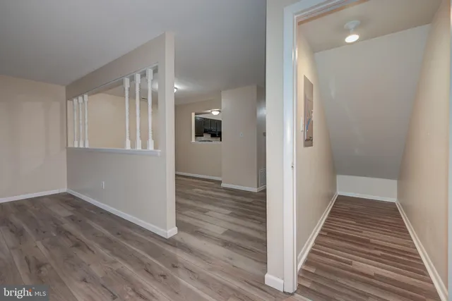 a view of a hallway with wooden floor