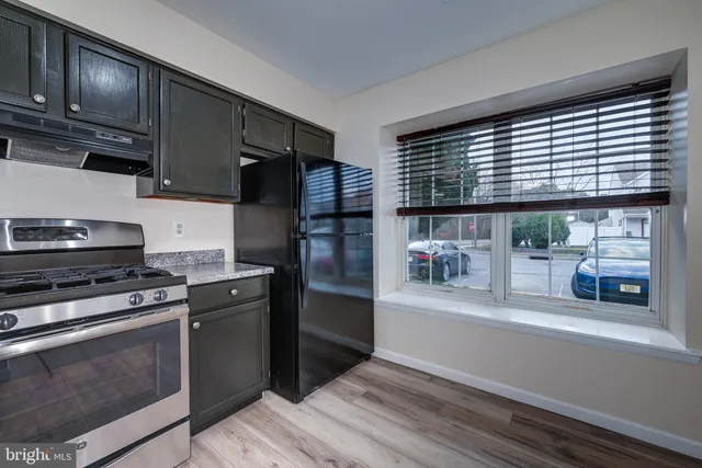 a kitchen with stainless steel appliances granite countertop a refrigerator and a stove