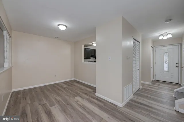a view of hallway with wooden floor