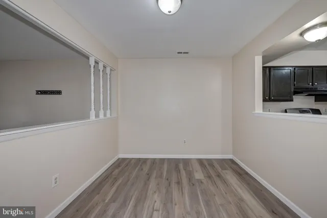 a view of a room with wooden floor and cabinet