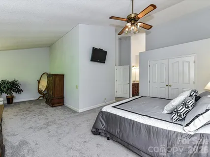 a bedroom with a bed and a chandelier