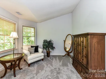 a living room with furniture a lamp a rug and a window