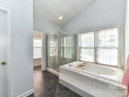 a spacious bedroom with a bed and a window