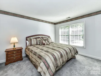 a bedroom with a bed and a tv on the dresser
