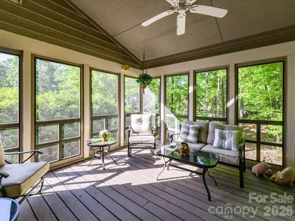 a living room with furniture and a floor to ceiling window