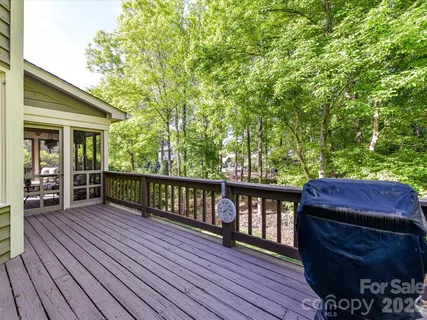 a view of a wooden deck and a yard