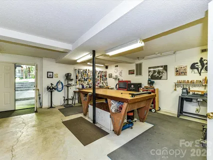 a living room with furniture flat screen tv and a table