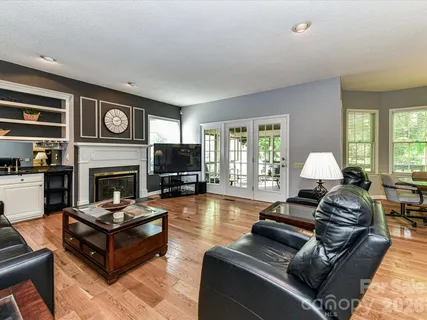 a living room with furniture fireplace and window