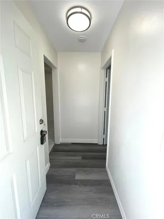 a view of room with wooden floor and window