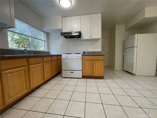 a kitchen with stainless steel appliances granite countertop a sink and a stove