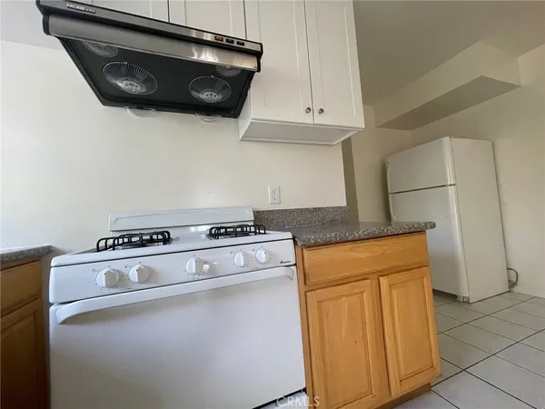 a stove top oven sitting inside of a kitchen
