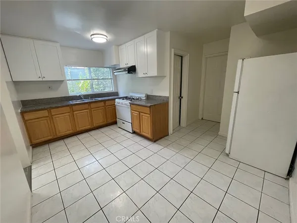 a kitchen with a cabinets a sink and a stove top oven