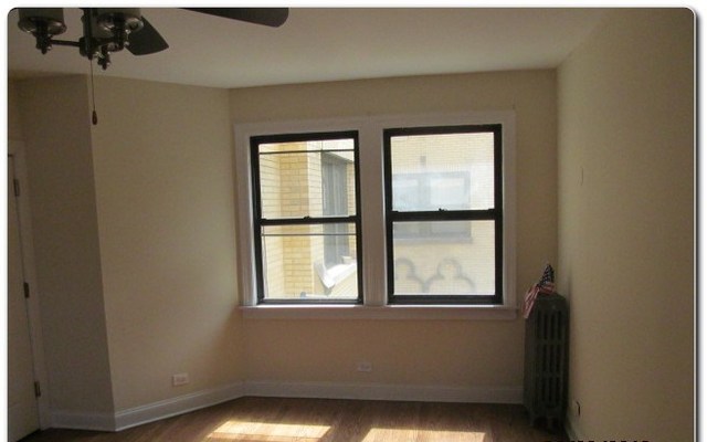 5655 North Spaulding Avenue, Unit 2W Chicago, IL 60659 - Photo 12 of 13 a view of an empty room with a window