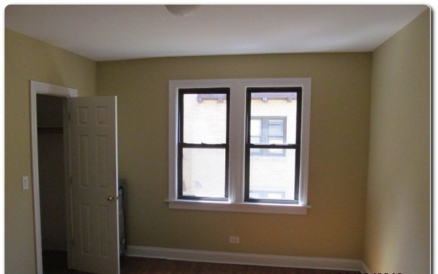 5655 North Spaulding Avenue, Unit 2W Chicago, IL 60659 - Photo 13 of 13 a view of an empty room with a window