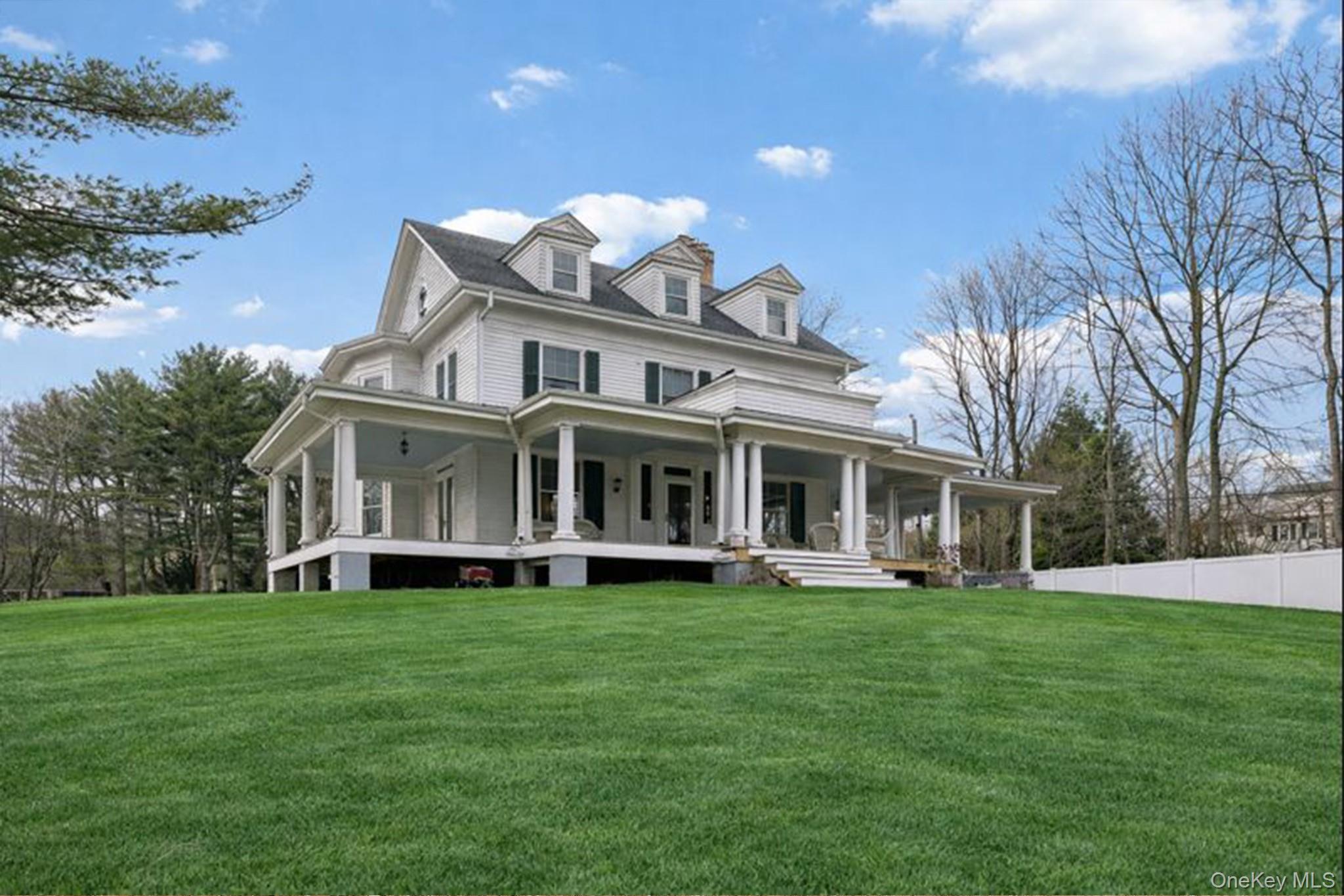 397 Split Rock Road Syosset, NY 11791 - Photo 3 of 29 a view of a house with a big yard and large trees