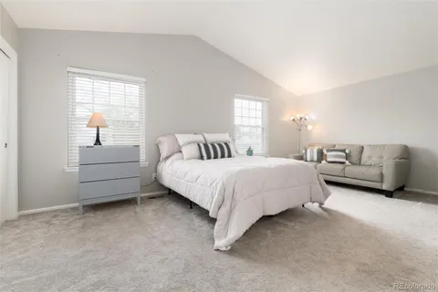 a bedroom with a bed and a lamp