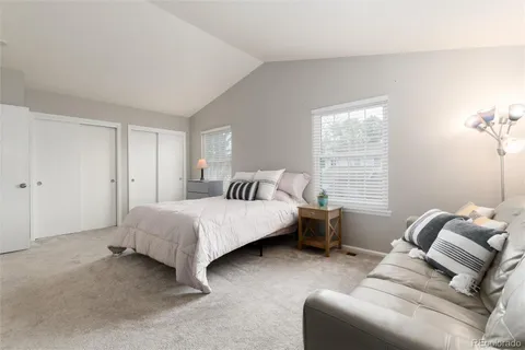 a bathroom with a granite countertop sink a toilet and a shower