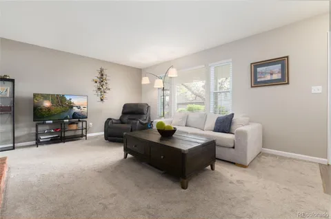 a kitchen with stainless steel appliances granite countertop a sink a stove a dining table and chairs