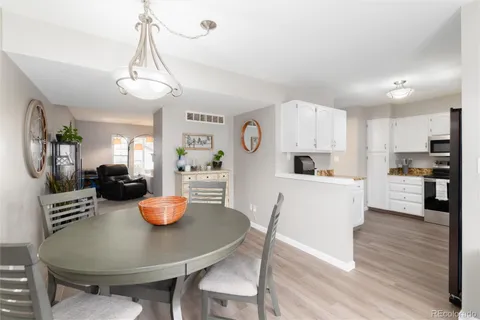 a kitchen with stainless steel appliances granite countertop a stove a sink dishwasher a refrigerator and a microwave