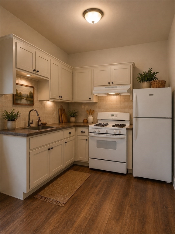 128 Shawmut Street, Unit 2 Chelsea, MA 02150 - Photo 9 of 12 a kitchen with granite countertop white cabinets and white appliances