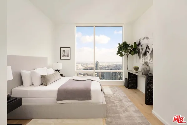 a bedroom with a large bed and a balcony view