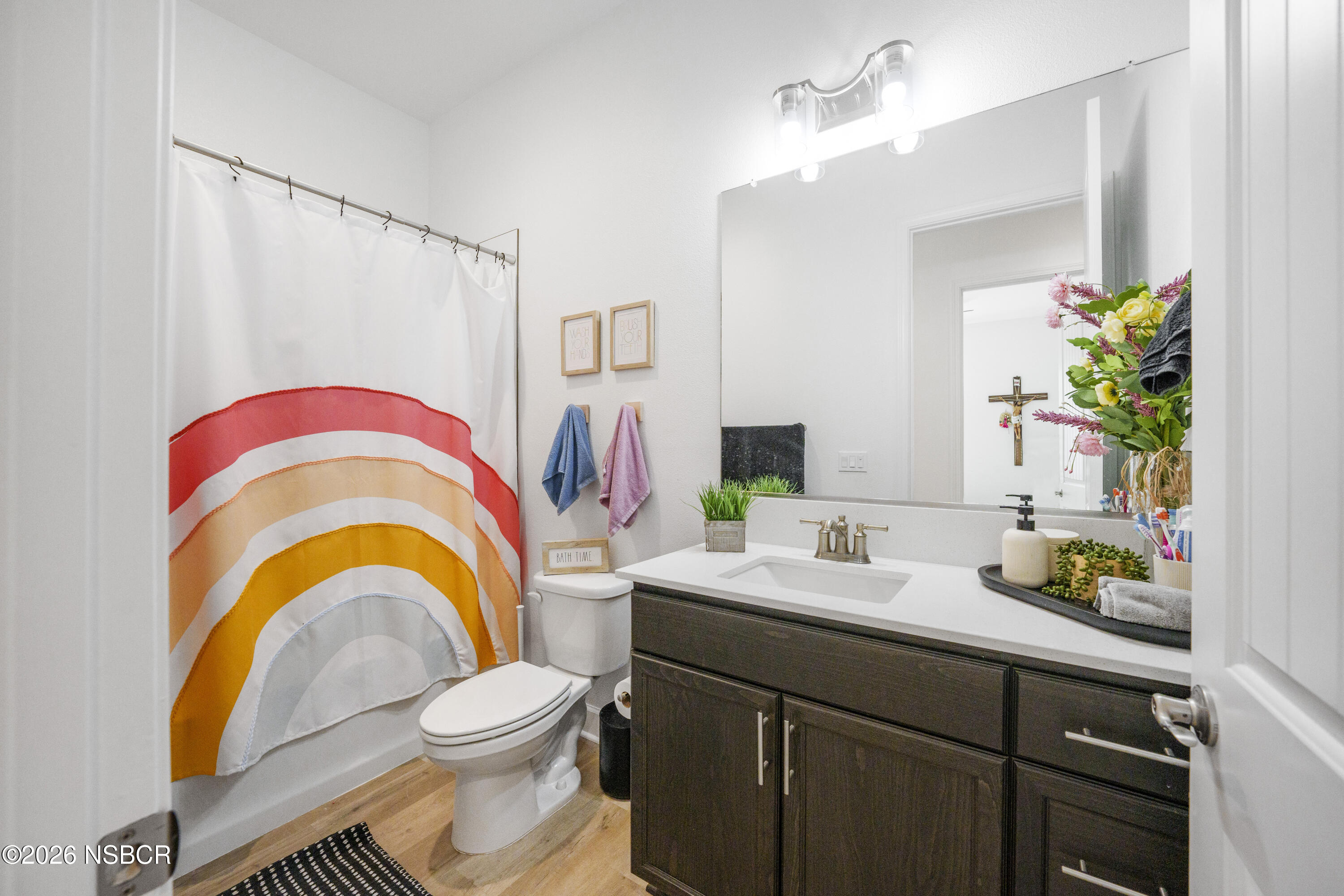 751 Skyview Lane Santa Maria, CA 93455 - Photo 29 of 31 a bathroom with a sink a mirror a toilet and a mirror