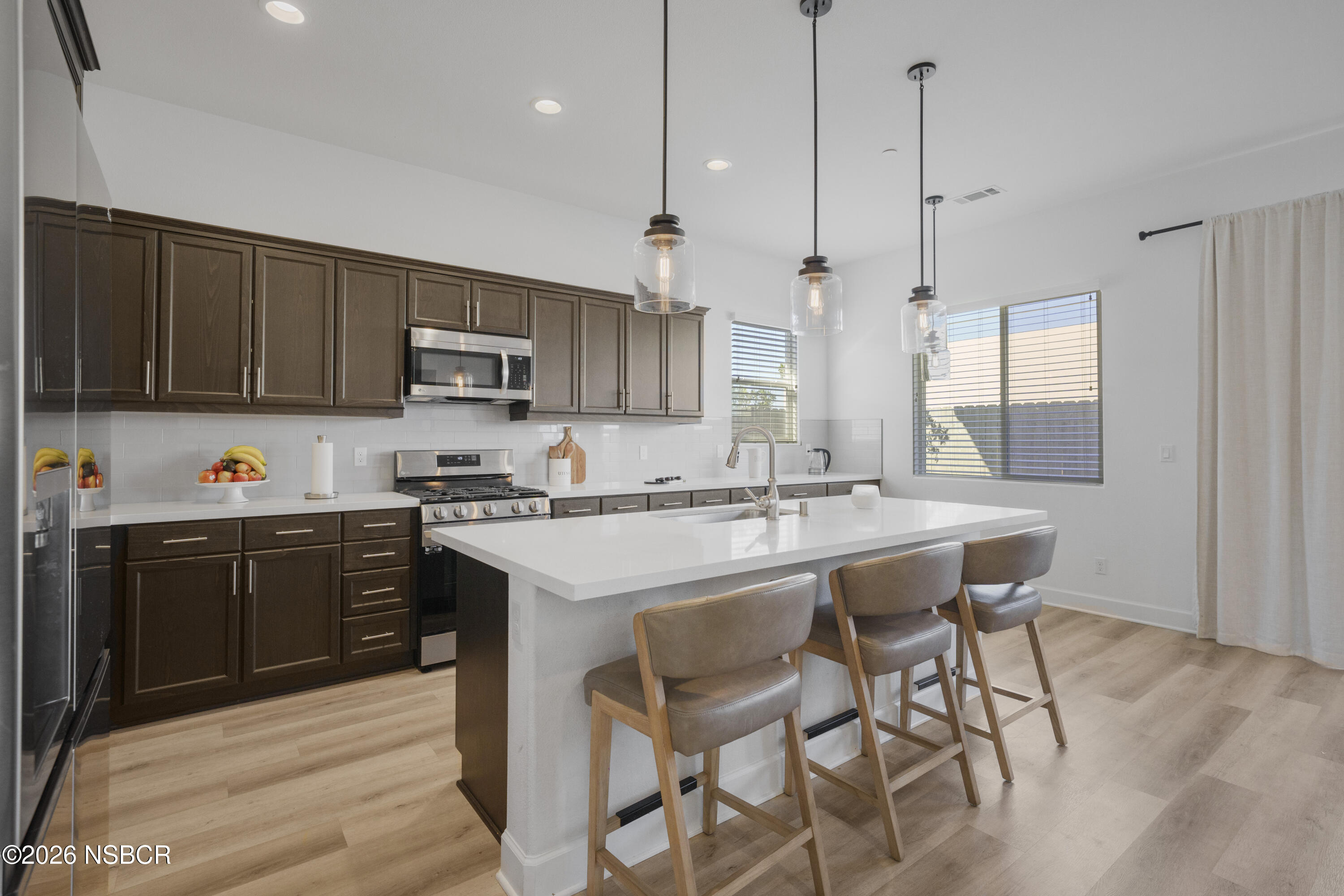 751 Skyview Lane Santa Maria, CA 93455 - Photo 7 of 31 a kitchen with a sink stove and microwave