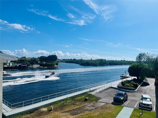 a view of a lake with couches chairs