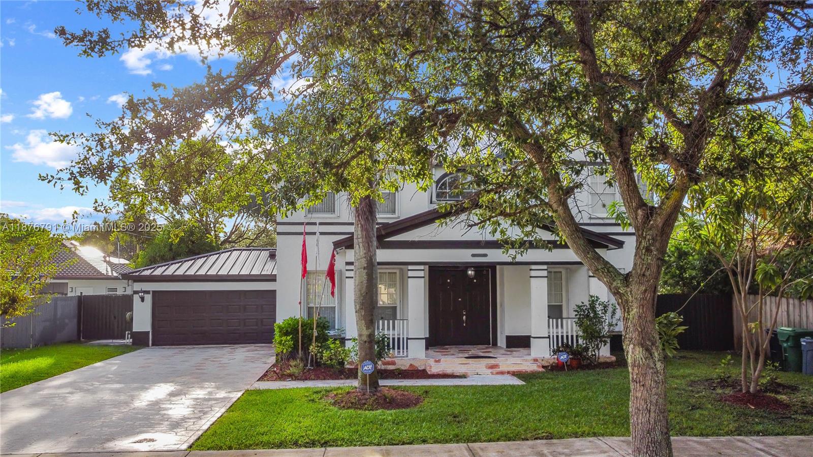 20235 Southwest 129th Avenue, Unit 20235 Miami, FL 33177 - Photo 1 of 35 a front view of a house with garden