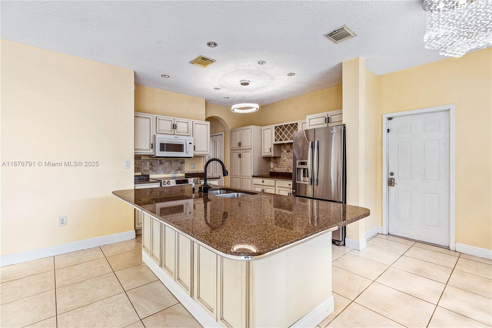 20235 Southwest 129th Avenue, Unit 20235 Miami, FL 33177 - Photo 13 of 35 a kitchen with stainless steel appliances granite countertop a sink and a refrigerator
