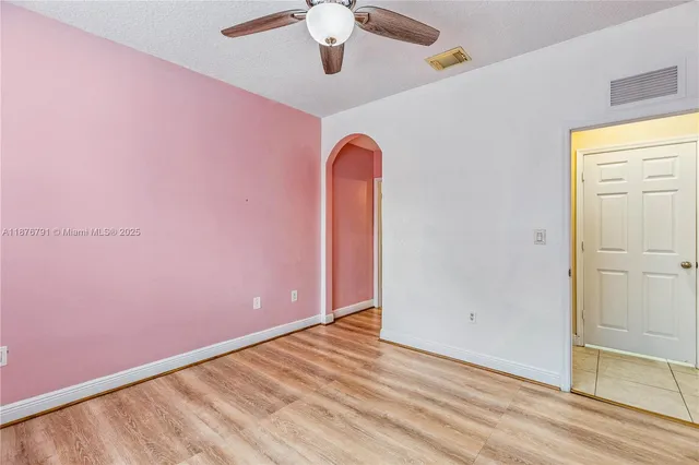 a view of a room with wooden floor