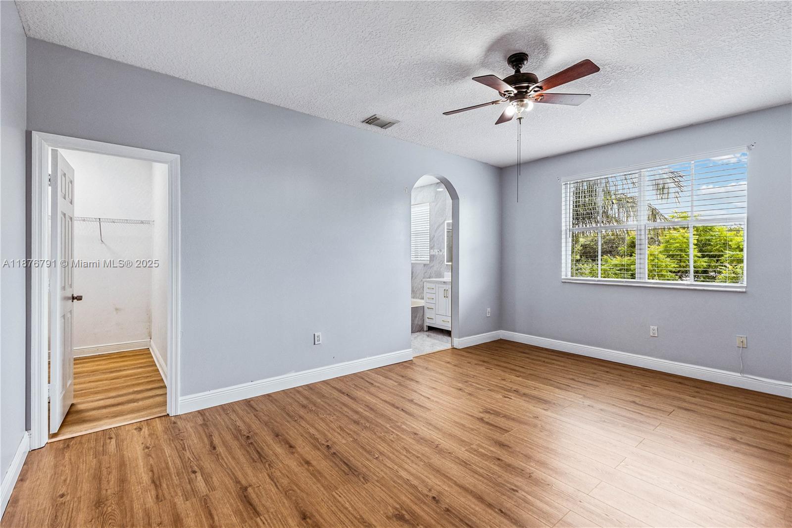 20235 Southwest 129th Avenue, Unit 20235 Miami, FL 33177 - Photo 19 of 35 wooden floor in an empty room with a window
