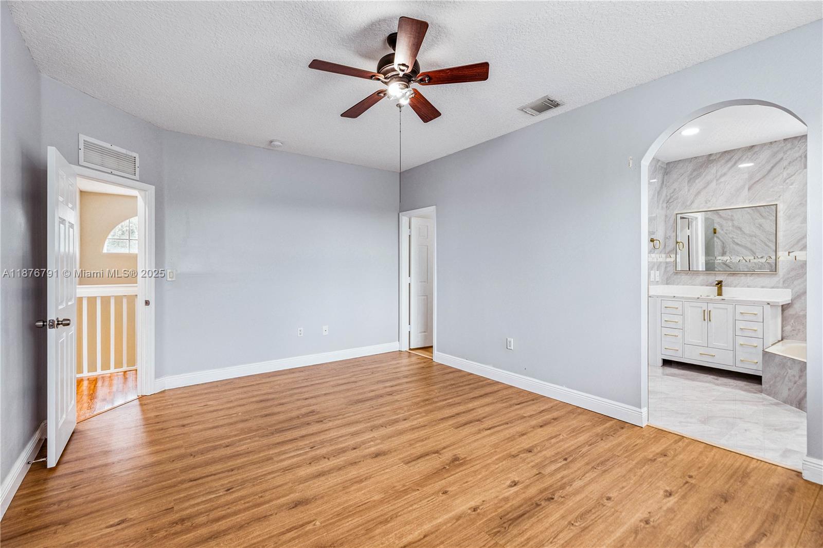 20235 Southwest 129th Avenue, Unit 20235 Miami, FL 33177 - Photo 20 of 35 a view of livingroom with hardwood floor and a ceiling fan