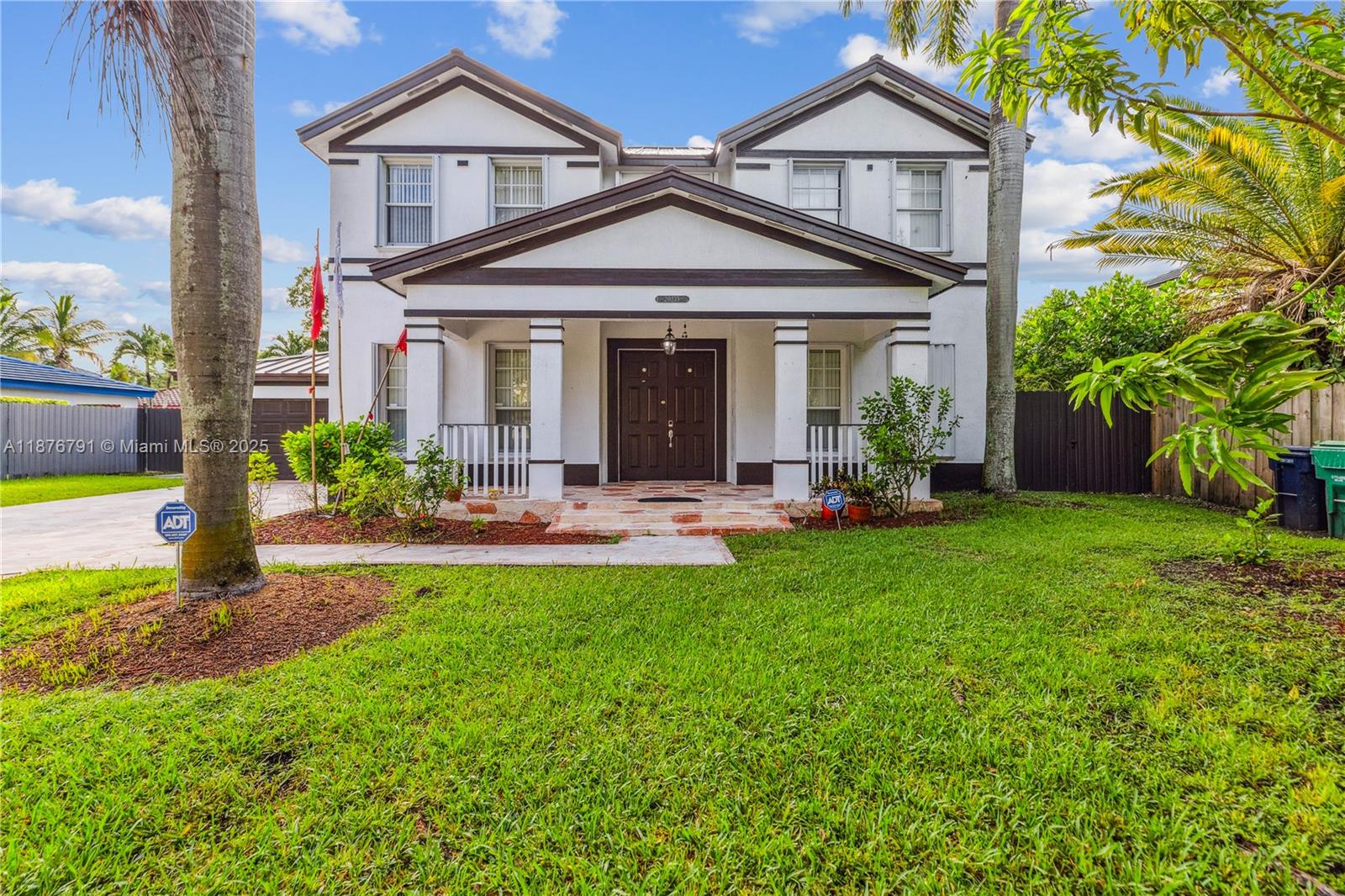 20235 Southwest 129th Avenue, Unit 20235 Miami, FL 33177 - Photo 2 of 35 a front view of a house with garden