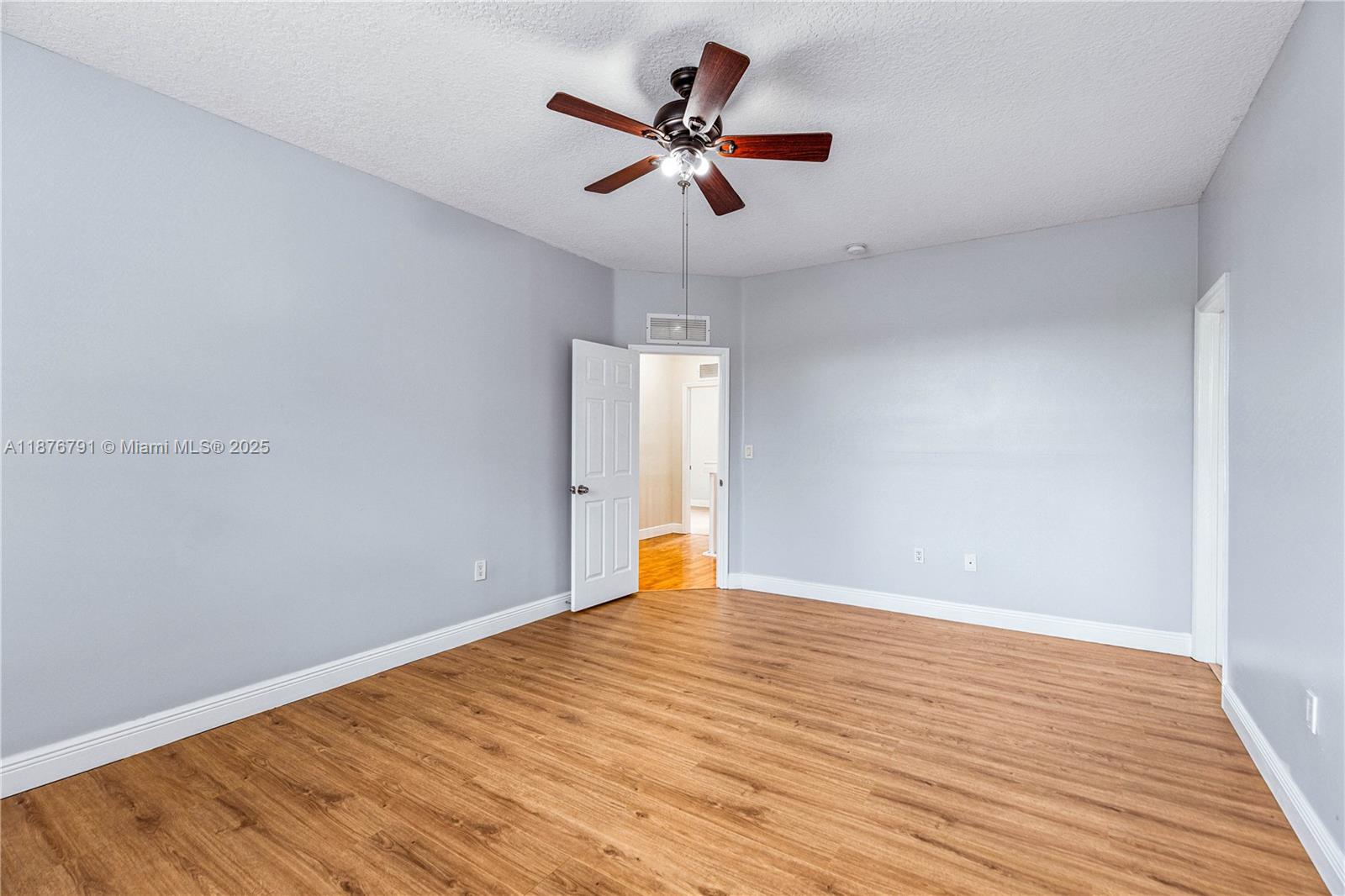 20235 Southwest 129th Avenue, Unit 20235 Miami, FL 33177 - Photo 21 of 35 wooden floor in an empty room with a window