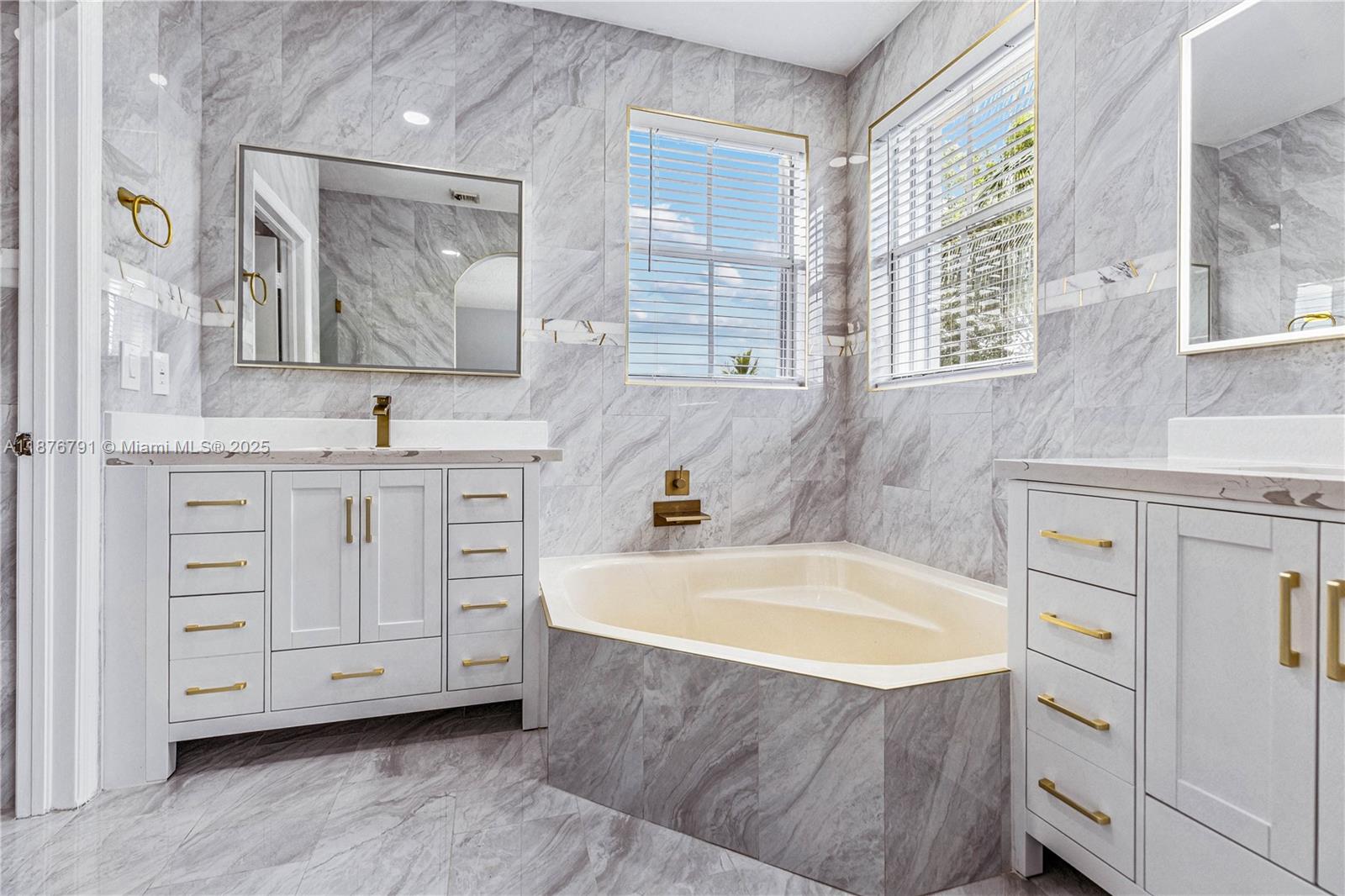 20235 Southwest 129th Avenue, Unit 20235 Miami, FL 33177 - Photo 22 of 35 a bathroom with a tub sink and mirror