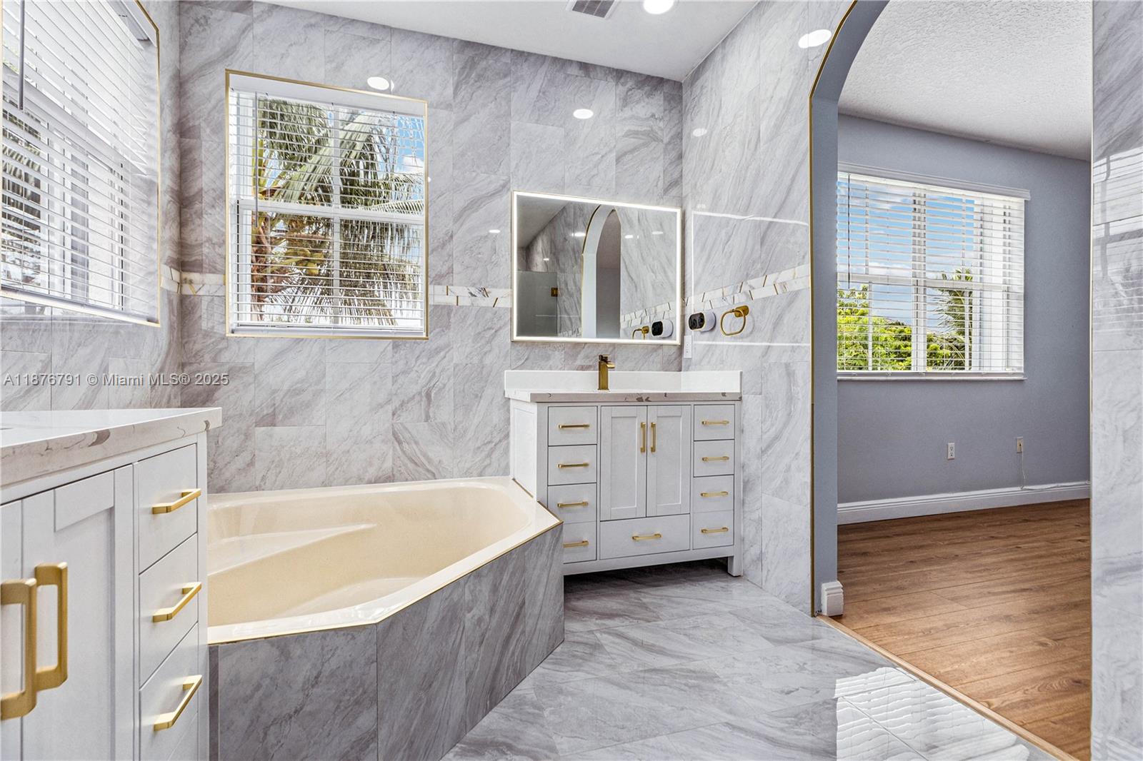 20235 Southwest 129th Avenue, Unit 20235 Miami, FL 33177 - Photo 24 of 35 a bathroom with a tub sink and mirror