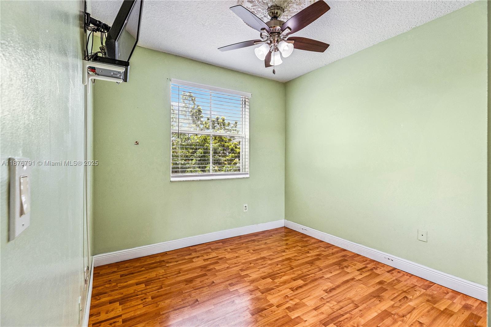 20235 Southwest 129th Avenue, Unit 20235 Miami, FL 33177 - Photo 27 of 35 a view of empty room with wooden floor and fan