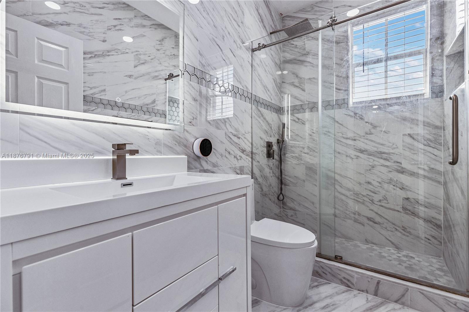 20235 Southwest 129th Avenue, Unit 20235 Miami, FL 33177 - Photo 29 of 35 a bathroom with a sink a toilet and shower