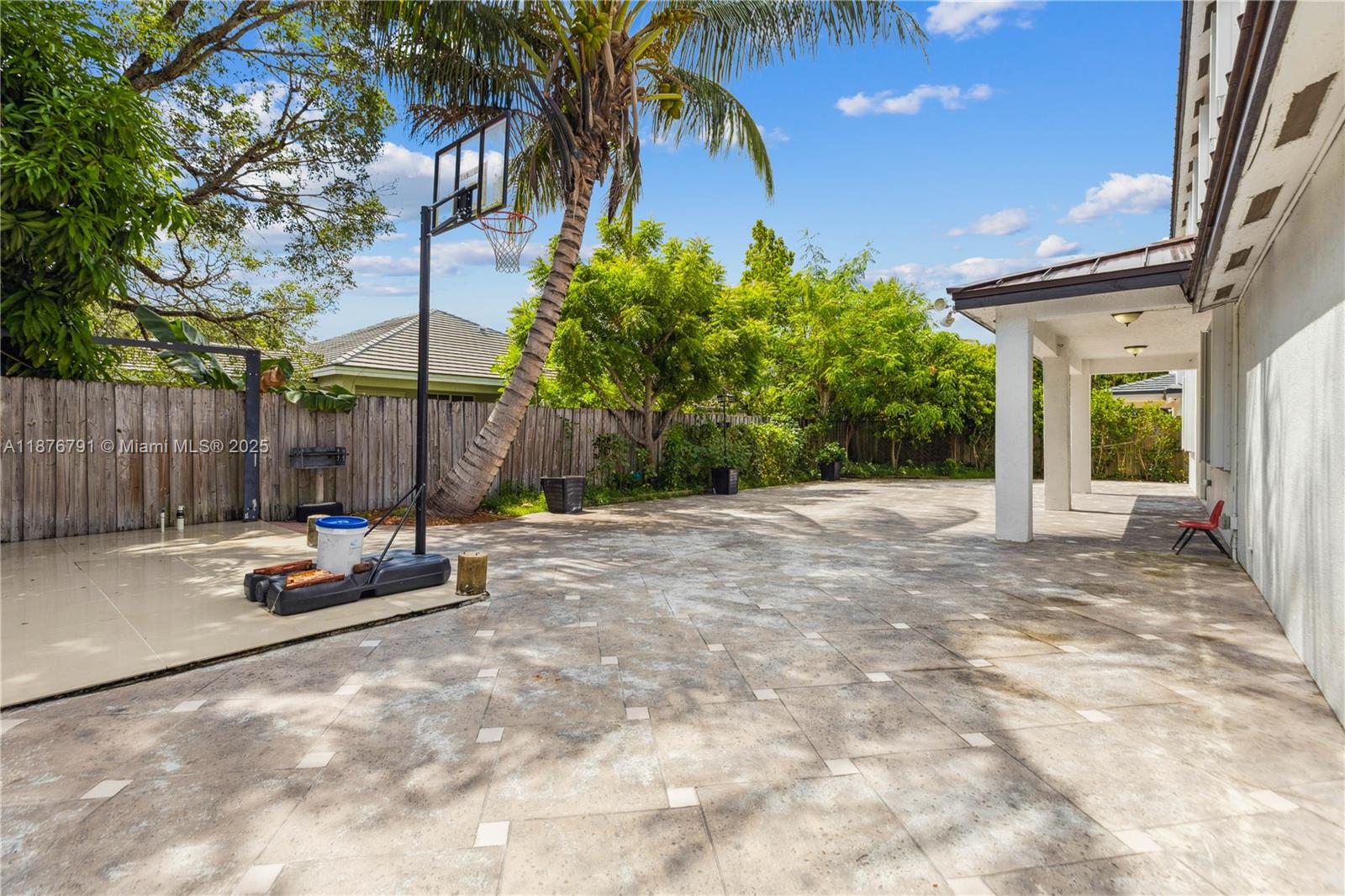 20235 Southwest 129th Avenue, Unit 20235 Miami, FL 33177 - Photo 32 of 35 a view of a backyard with a patio