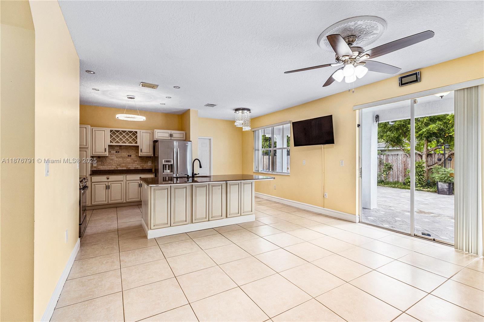 20235 Southwest 129th Avenue, Unit 20235 Miami, FL 33177 - Photo 10 of 35 a view of kitchen with stainless steel appliances kitchen island granite countertop a refrigerator oven a sink and dishwasher