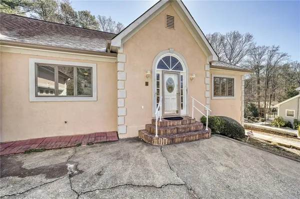 a view of a white house with a yard