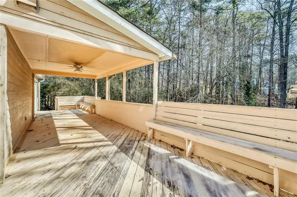 a view of balcony with wooden floor and fence