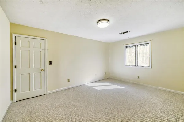 a view of empty room with wooden floor and cabinet