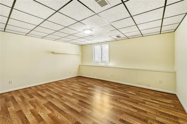 a view of empty room with wooden floor