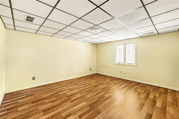a view of a room with wooden floor and brick walls
