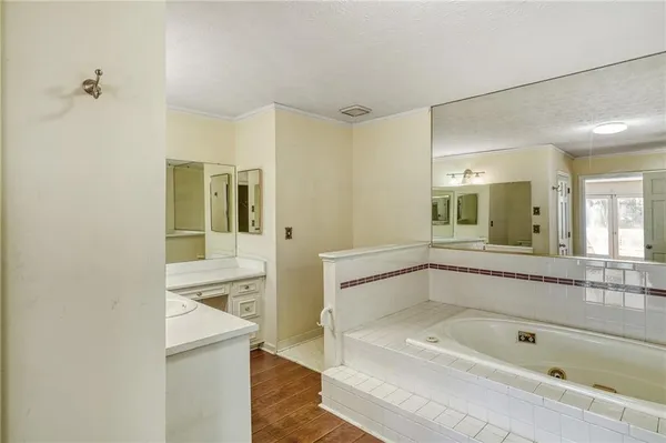 a spacious bathroom with a shower sink mirror and bathtub