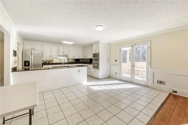 a view of a room with wooden floor
