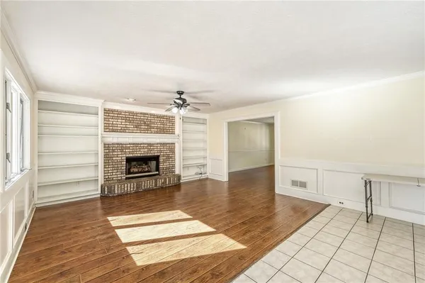 a view of an empty room and fire place