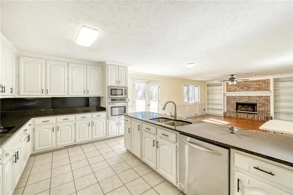 a kitchen with stainless steel appliances granite countertop a sink and cabinets